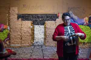 In this Friday, Aug. 18, 2017 photo, Las Vegas artist Justin Favela is installing his latest piñata piece in the Piñata Exhibit at the National Hispanic Cultural Center. Albuquerque, N.M.