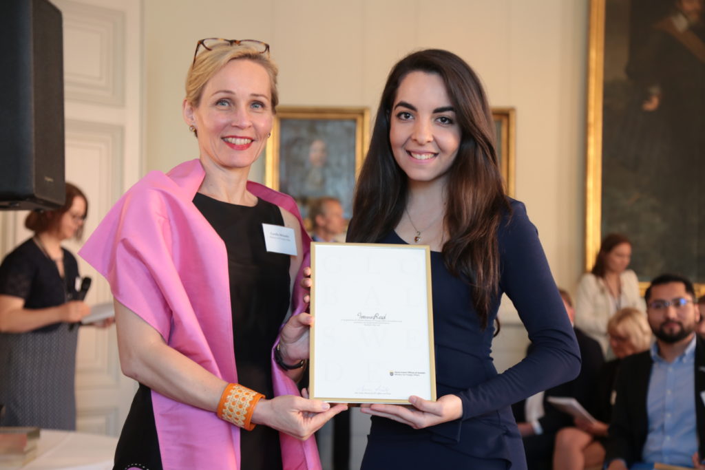 Camilla Mellander entrega reconocimiento a la estudiante dominicana Ivanna Read, en Suecia.